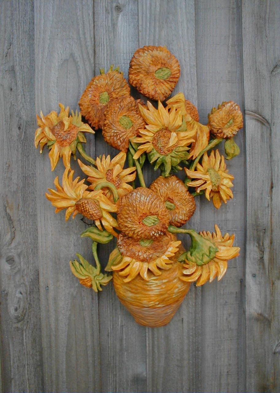 image of a painted basswood woodcarving, bas relief interpretation of Vincent van Gogh sunflower series